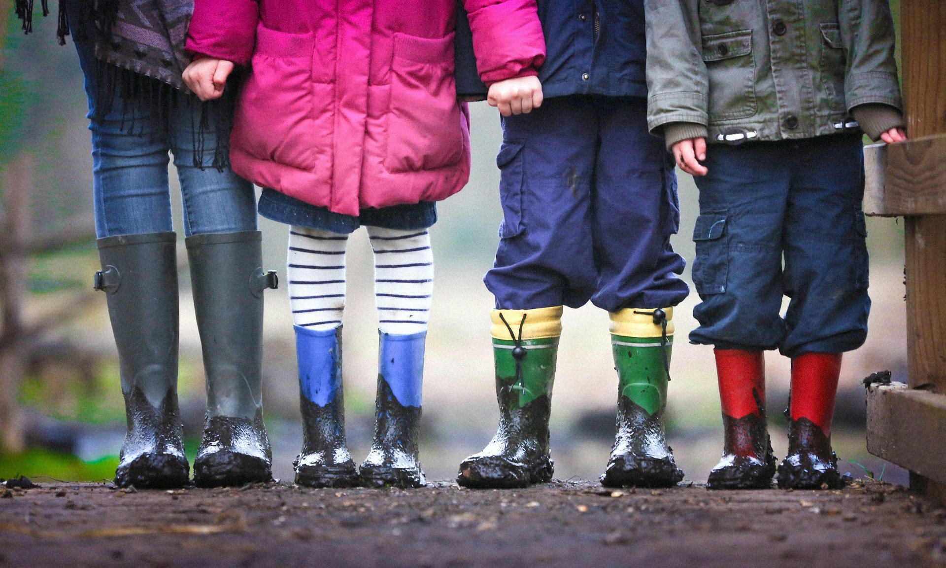 Kids with boots on in mud